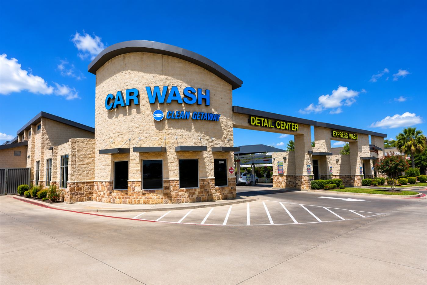 Clean Getaway storefront on a bright blue-sky day: Car Wash tower with the Detail Center and Express Wash archways