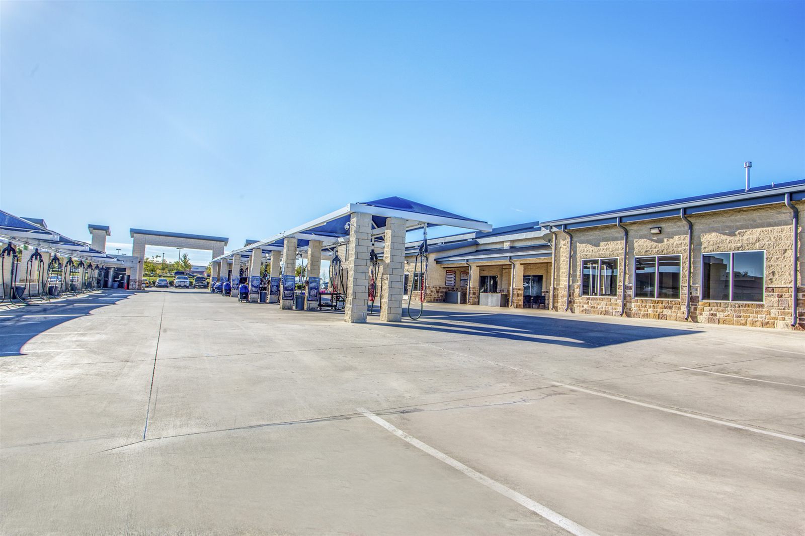 Rows of free self-serve vacuum stations under blue canopies